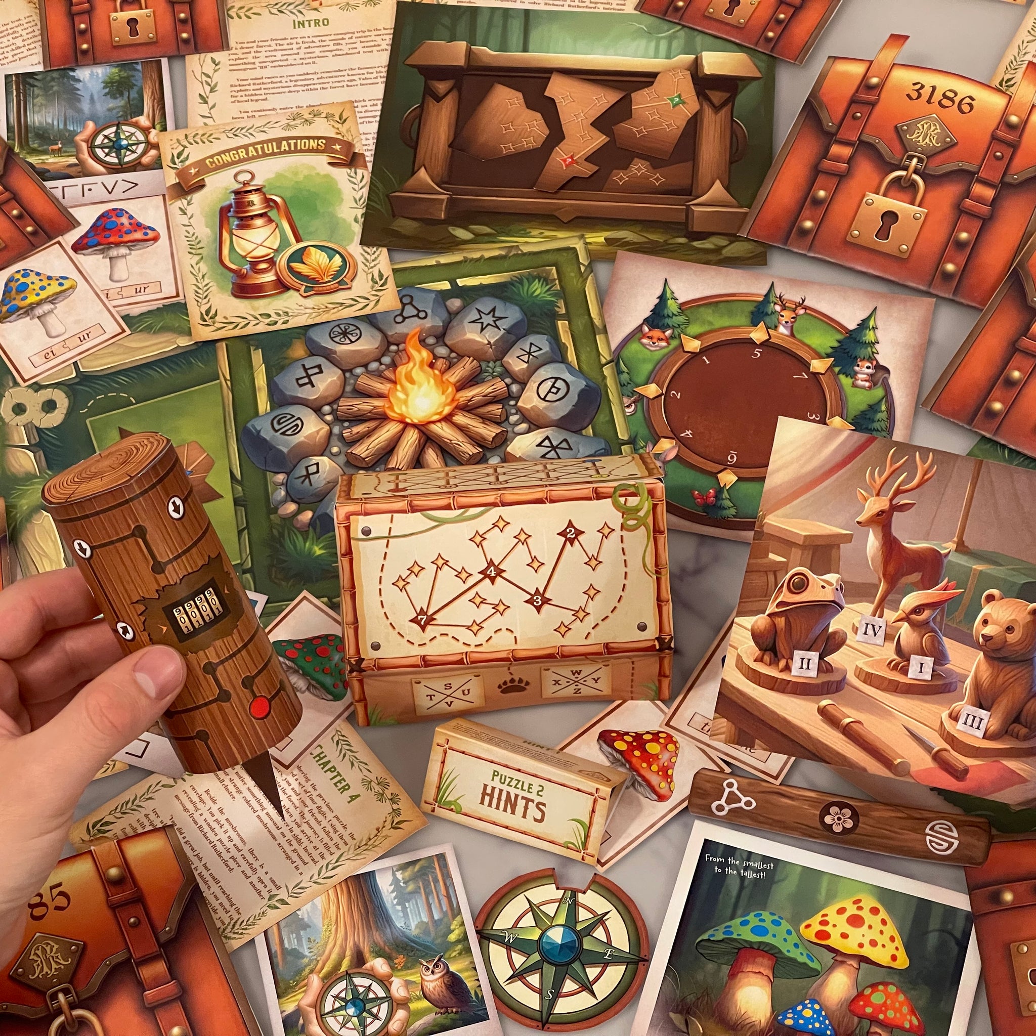 The image features the Escape Room Clues of Explorer's Lost Camp Printable Escape Room Kit. The printable game features six immersive puzzles. In the image, game materials of mushrooms, animals and wood chests fill the table.