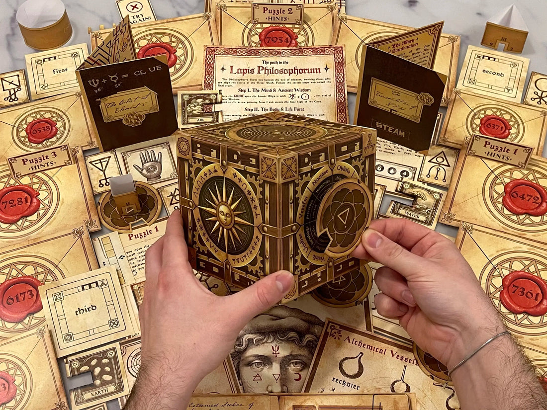 The game cover artwork of our alchemy-themed printable escape room. This escape room for adults features amazing artwork and complex escape room puzzles. Turn your home into an escape room with The Alchemist’s Box, a printable escape room filled with challenging puzzles and hidden secrets. Download, print, and play instantly!