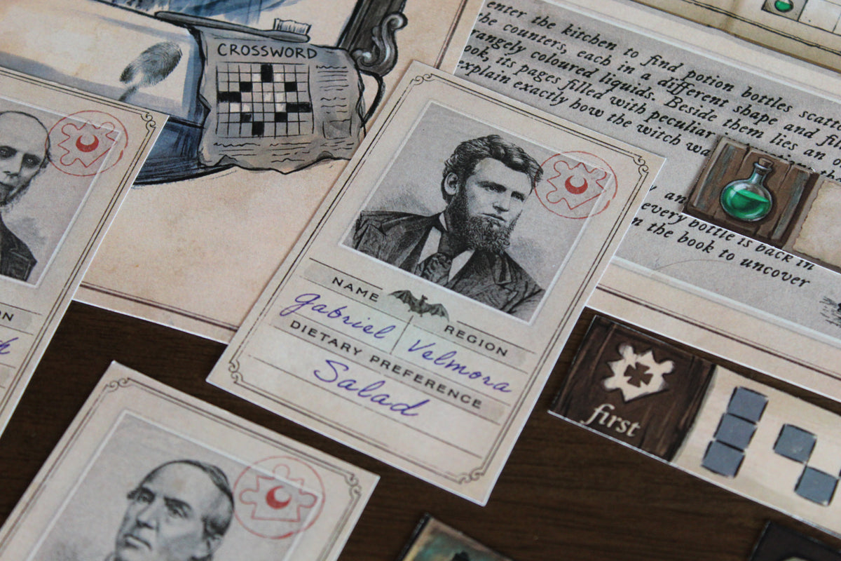 Close-up of vampire guest card Gabriel Velmora from Dracula’s dinner puzzle in The Halloween House printable escape room, surrounded by potion materials, Bloody Mary’s mirror, final code pieces, and other Halloween clues. This spooky DIY escape room for adults and teens includes a detailed vampire seating-logic challenge where players use guest identities, regions, dietary preferences, and placement rules to uncover a secret word as part of the larger haunted-house mystery.