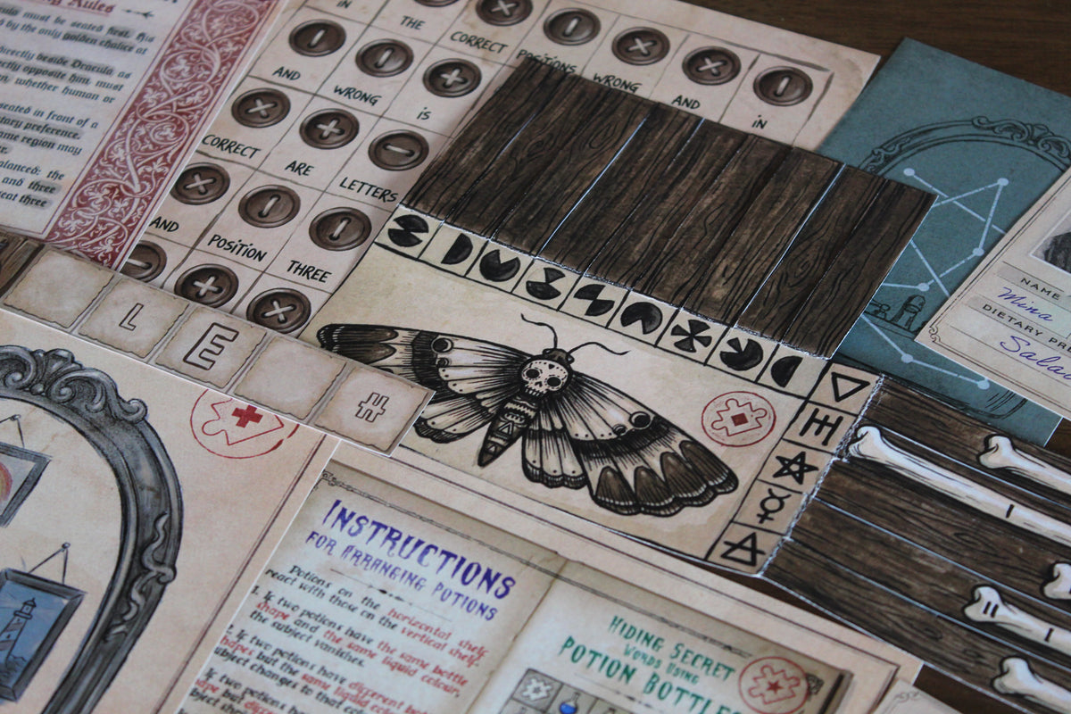 Close-up of the cemetery decoder puzzle from The Halloween House printable escape room, showing a large illustrated moth, folding wooden strips, symbols, bones, potion instructions, and other Halloween puzzle materials. This spooky DIY escape room for adults and teens uses Morse code, folding mechanics, symbol matching, deduction, and physical paper manipulation. The cemetery challenge is one of five monster-themed puzzles that eventually combine into the final escape code.