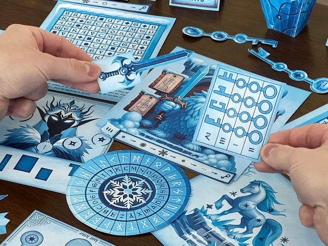 Hands holding puzzle pieces from The Snow Queen printable escape room by MysteryLocks, featuring a glowing blue sword and a key cipher sheet. The table is filled with icy logic puzzles, runic decoder wheels, and illustrated winter scenes. This DIY printable escape room lets players solve clues, unlock codes, and uncover the secrets of the frozen realm — perfect for families, classrooms, or escape room fans seeking a creative winter puzzle adventure at home.